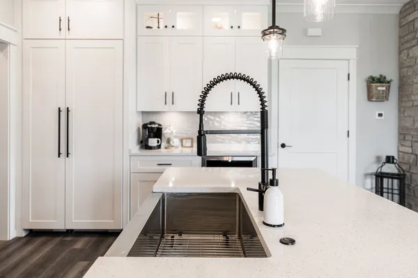 a kitchen with a sink a stove and cabinets