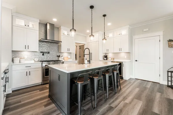 a kitchen with white cabinets and white appliances