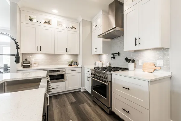 a open kitchen with stainless steel appliances granite countertop a stove top oven and a sink