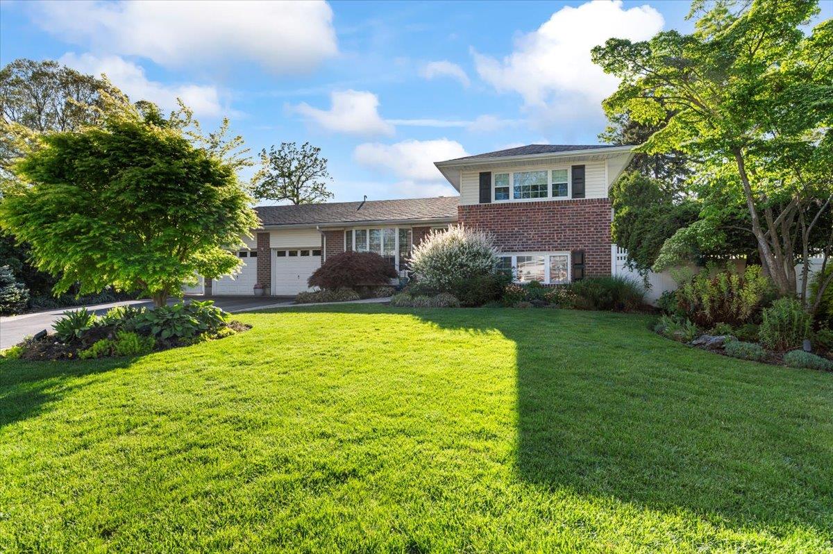 a view of a house with a yard patio and swimming pool
