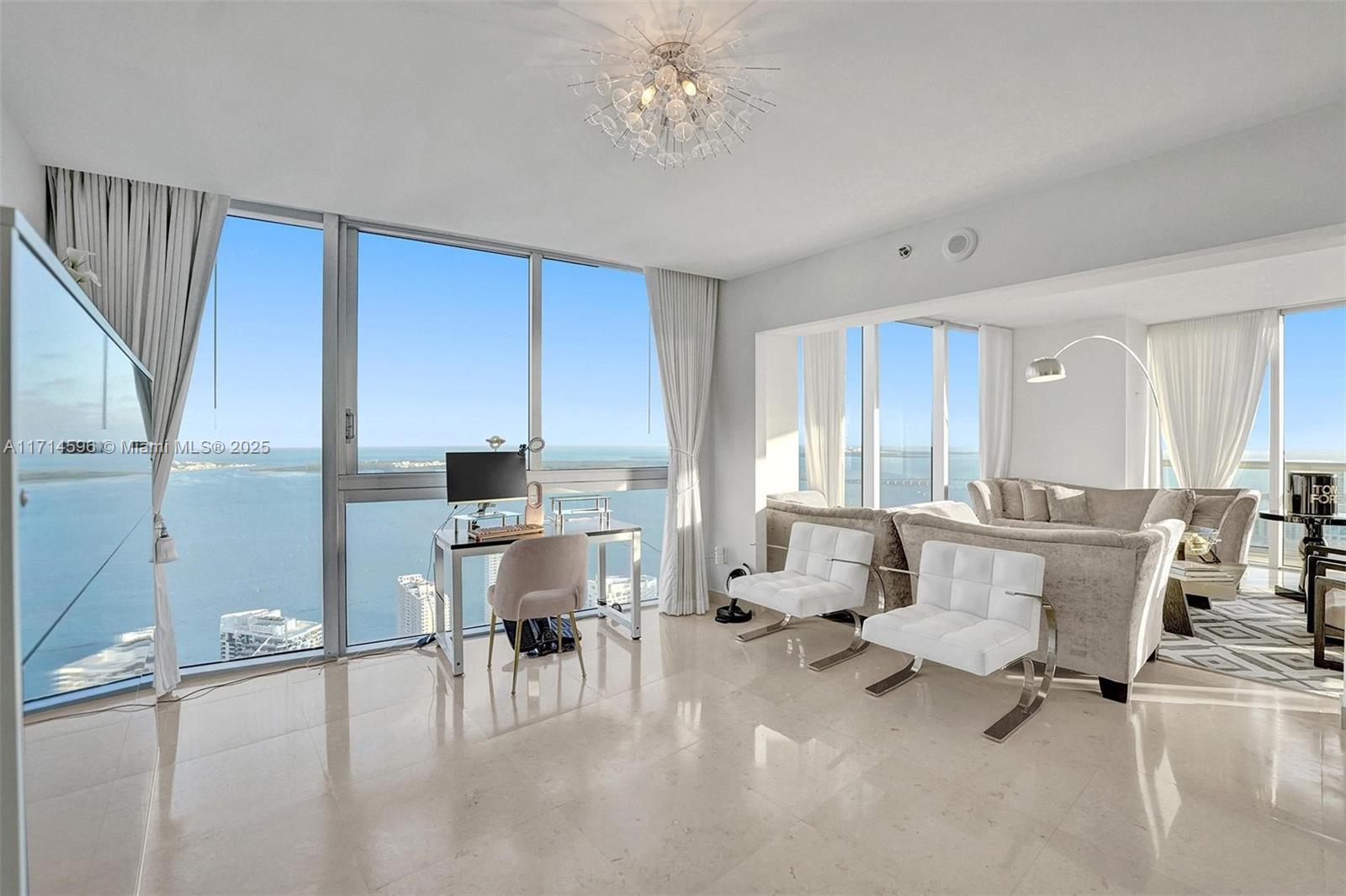 495 Brickell Avenue, Unit PH5701 Miami, FL 33131 - Photo 11 of 31 a living room with furniture a dining table and a large window