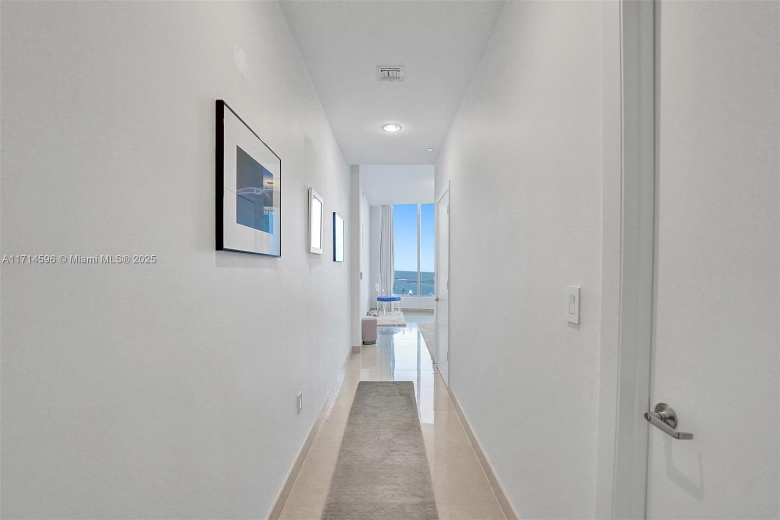 495 Brickell Avenue, Unit PH5701 Miami, FL 33131 - Photo 16 of 31 a view of a hallway with wooden floor and a bathroom