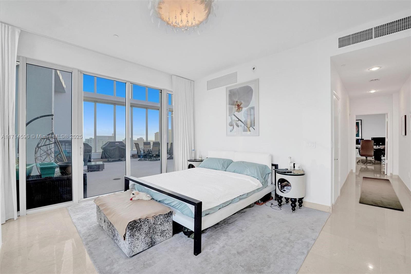 495 Brickell Avenue, Unit PH5701 Miami, FL 33131 - Photo 17 of 31 a bedroom with a bed and a large window