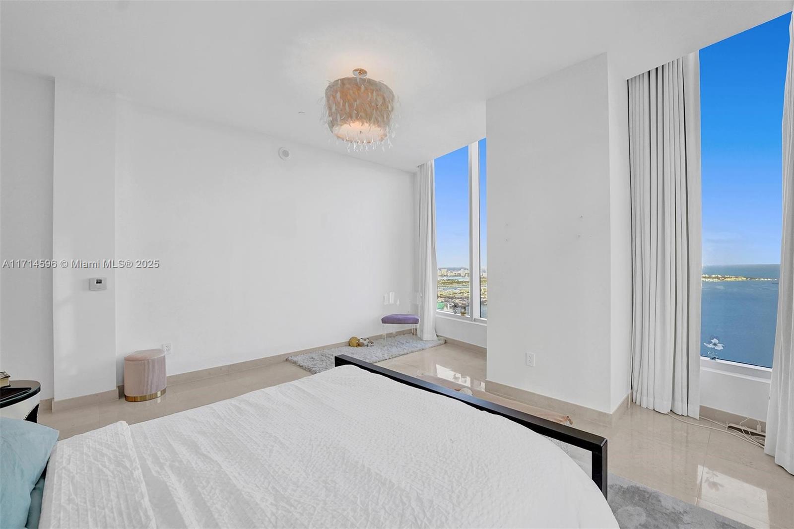 495 Brickell Avenue, Unit PH5701 Miami, FL 33131 - Photo 19 of 31 a bedroom with a bed and a window