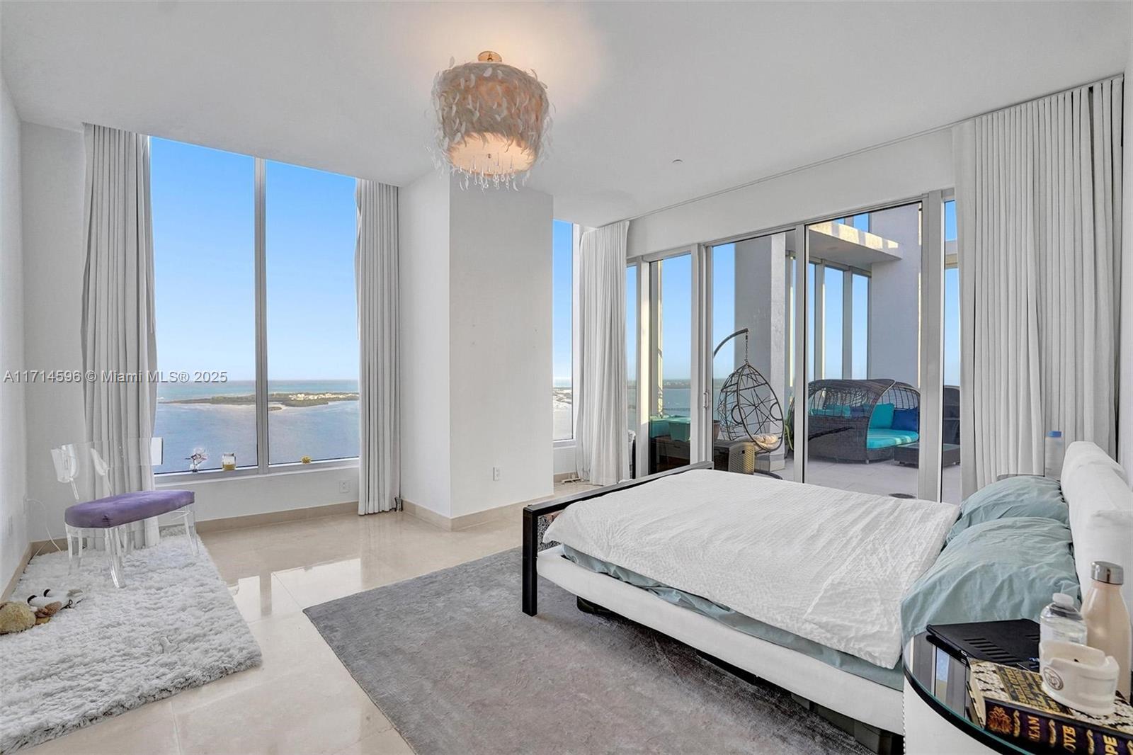 495 Brickell Avenue, Unit PH5701 Miami, FL 33131 - Photo 20 of 31 a bedroom with a bed and glass window