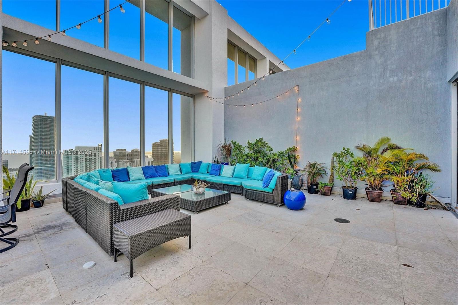 495 Brickell Avenue, Unit PH5701 Miami, FL 33131 - Photo 24 of 31 a building outdoor space with patio furniture and potted plants