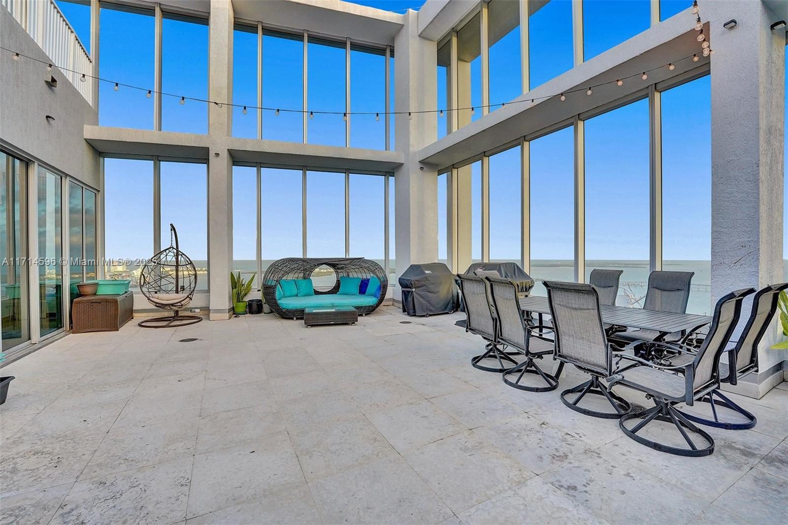 495 Brickell Avenue, Unit PH5701 Miami, FL 33131 - Photo 27 of 31 a view of a chairs with potted plants in front of building