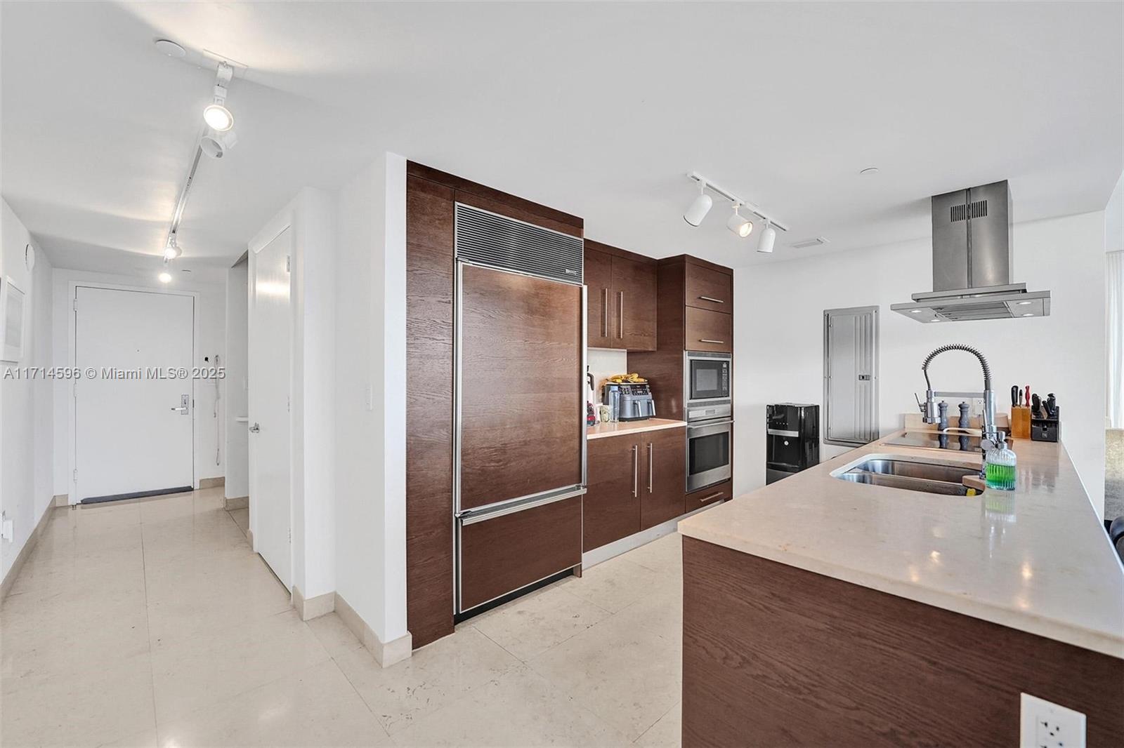 495 Brickell Avenue, Unit PH5701 Miami, FL 33131 - Photo 5 of 31 a kitchen with stainless steel appliances kitchen island granite countertop a refrigerator and a sink