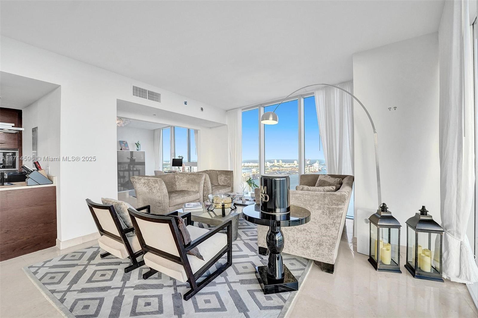 495 Brickell Avenue, Unit PH5701 Miami, FL 33131 - Photo 6 of 31 a living room with furniture a rug and white walls