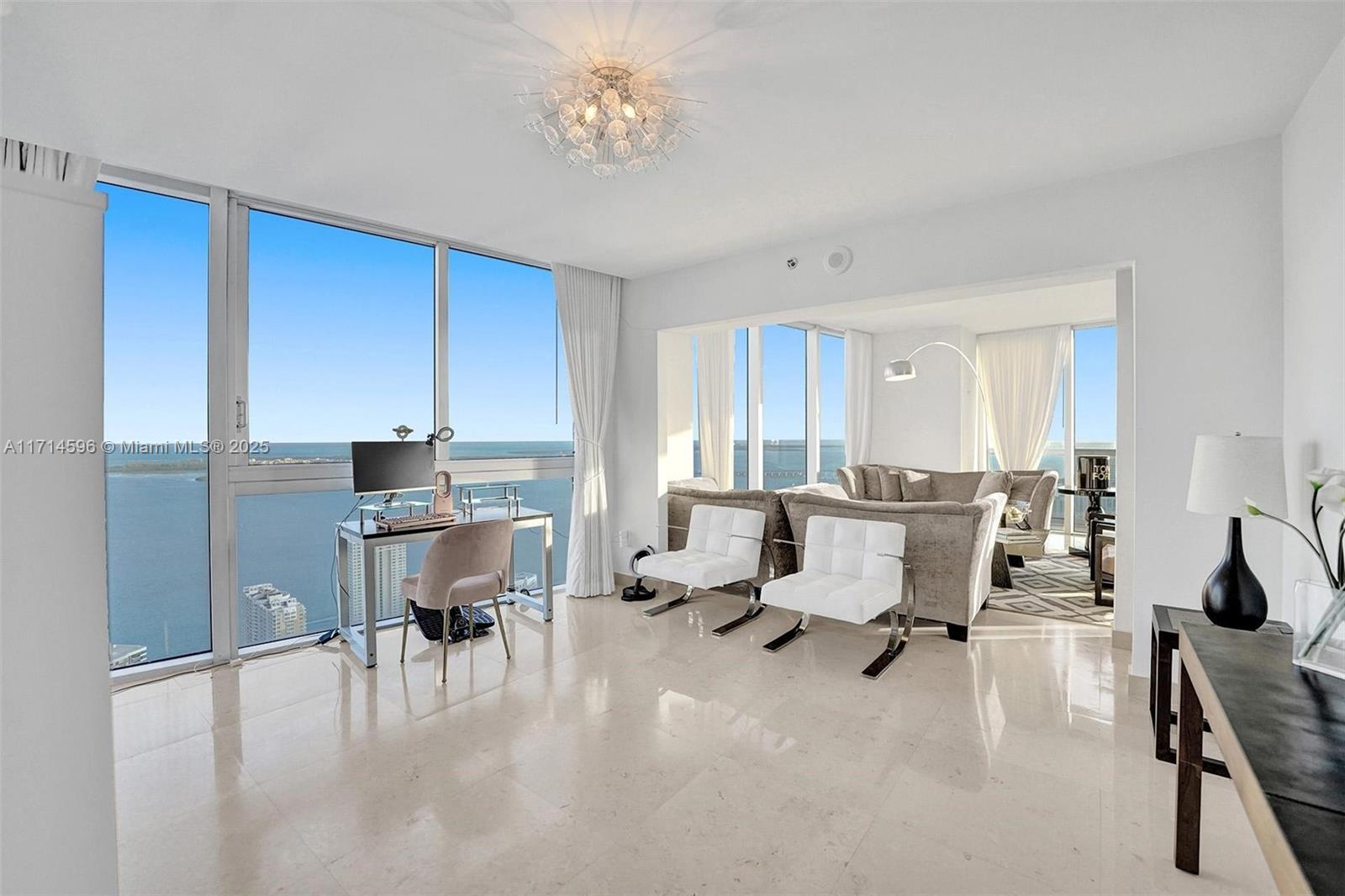 495 Brickell Avenue, Unit PH5701 Miami, FL 33131 - Photo 10 of 31 a workspace with furniture and a chandelier