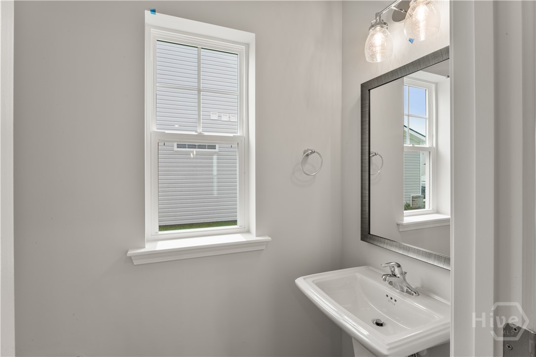 29 Blues Drive Pooler, GA 31322 - Photo 30 of 40 Downstairs powder room. Upgraded "logan square" pedestal sink, framed mirror.