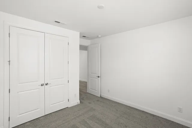 an empty room with closet area