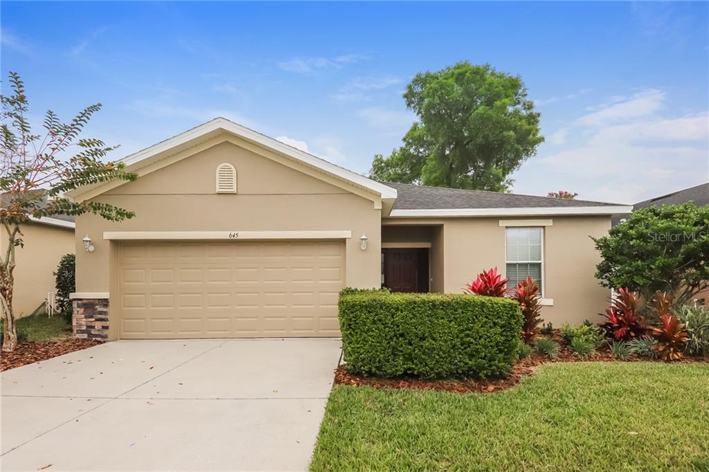 645 Breezeway Court Brandon, FL 33511 - Photo 1 of 1 a front view of a house with a yard and garage