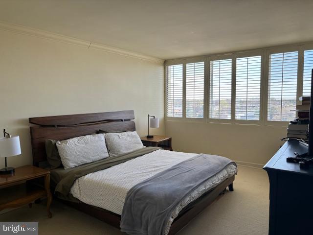 5101 River Road, Unit 1911 Bethesda, MD 20816 - Photo 18 of 32 a bed sitting in a bedroom next to a window
