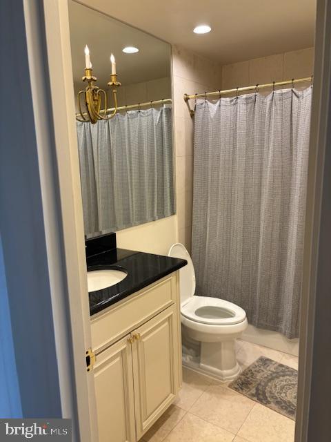 5101 River Road, Unit 1911 Bethesda, MD 20816 - Photo 23 of 32 a bathroom with a sink a toilet a mirror and shower curtain