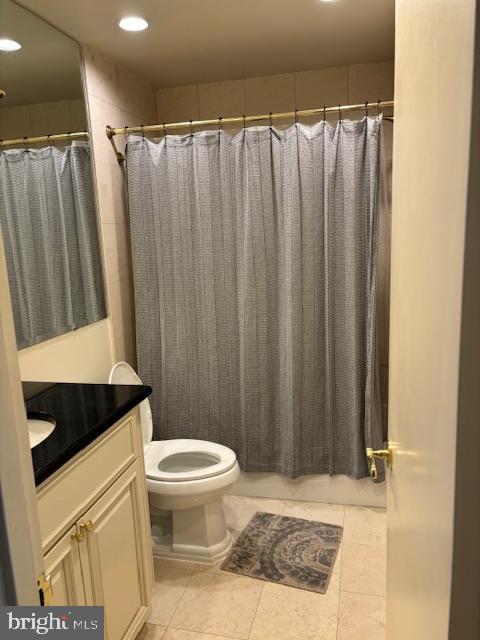 5101 River Road, Unit 1911 Bethesda, MD 20816 - Photo 32 of 32 a bathroom with a sink a toilet a mirror and shower curtain