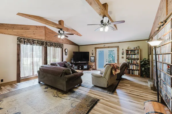 a living room with furniture and large windows