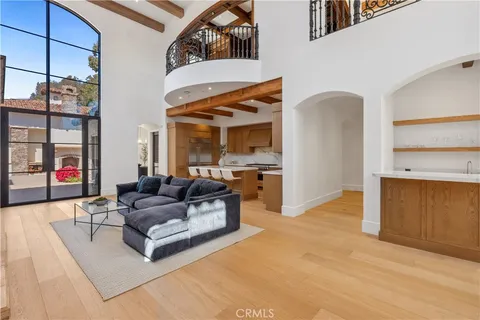 a spacious bedroom with a large bed and a potted plant
