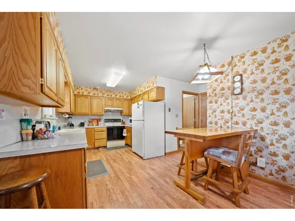a kitchen view of a dining table chairs and chandelier