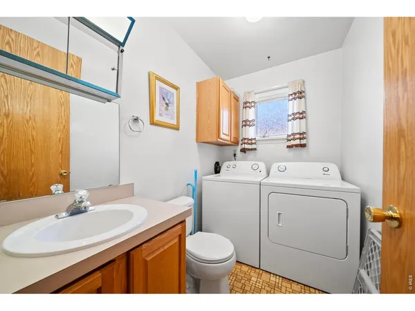 a bathroom with a sink toilet and a mirror