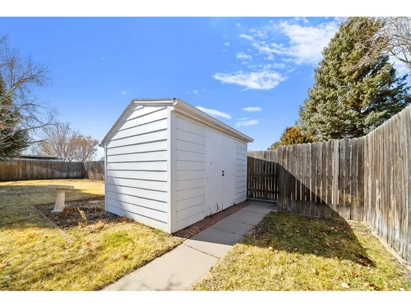 a view of a backyard with wooden fence