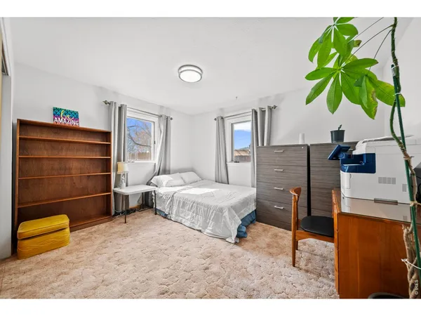 a bedroom with a bed table and a potted plant