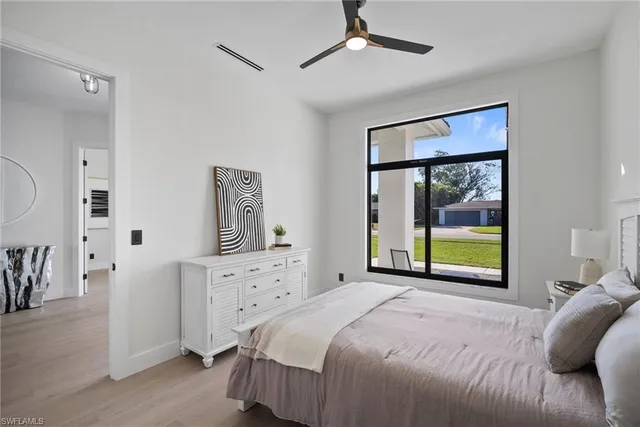 a bedroom with a bed and a large window