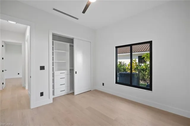 an empty room with windows and closet