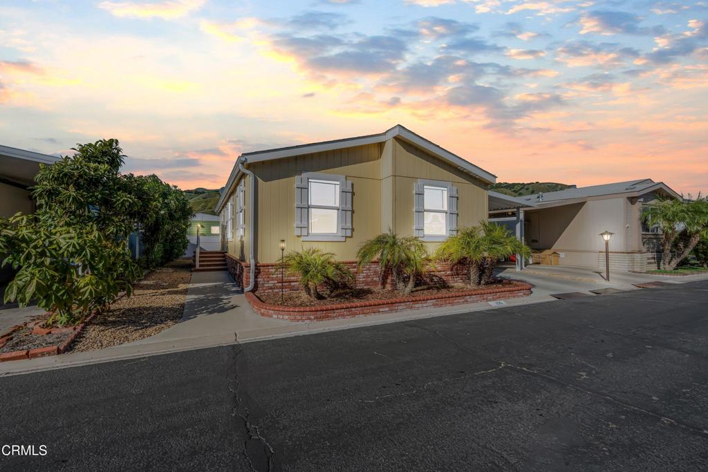 250 East Telegraph Road, Unit 155 Fillmore, CA 93015 - Photo 1 of 39 a front view of a house with a yard and potted plants