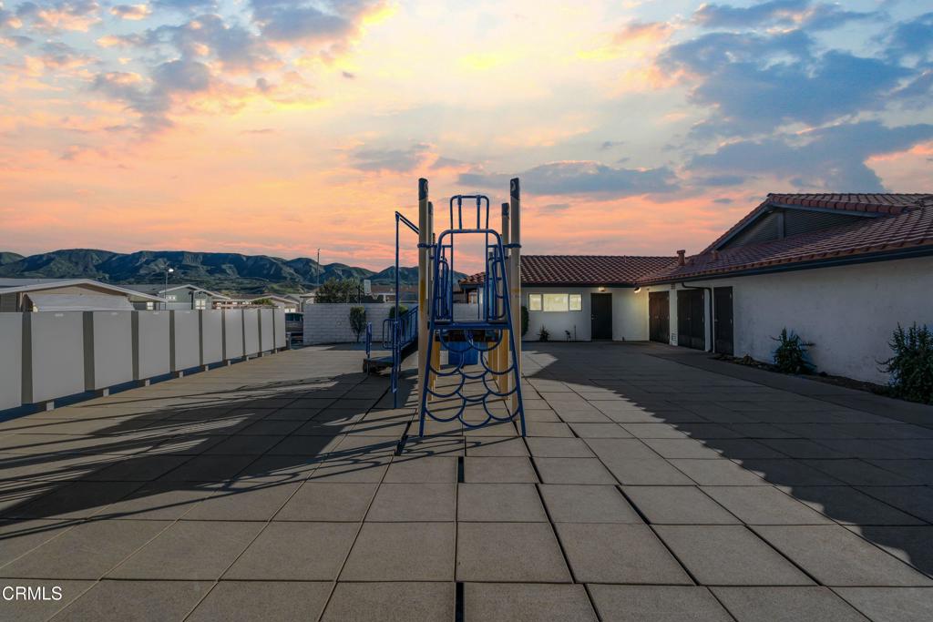 250 East Telegraph Road, Unit 155 Fillmore, CA 93015 - Photo 32 of 39 a view of a patio with table and chairs with wooden fence