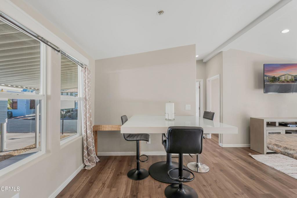 250 East Telegraph Road, Unit 155 Fillmore, CA 93015 - Photo 7 of 39 a view of a workspace with furniture and wooden floor