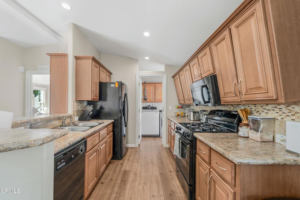 250 East Telegraph Road, Unit 155 Fillmore, CA 93015 - Photo 8 of 39 a kitchen with stainless steel appliances granite countertop a stove a sink dishwasher and a refrigerator