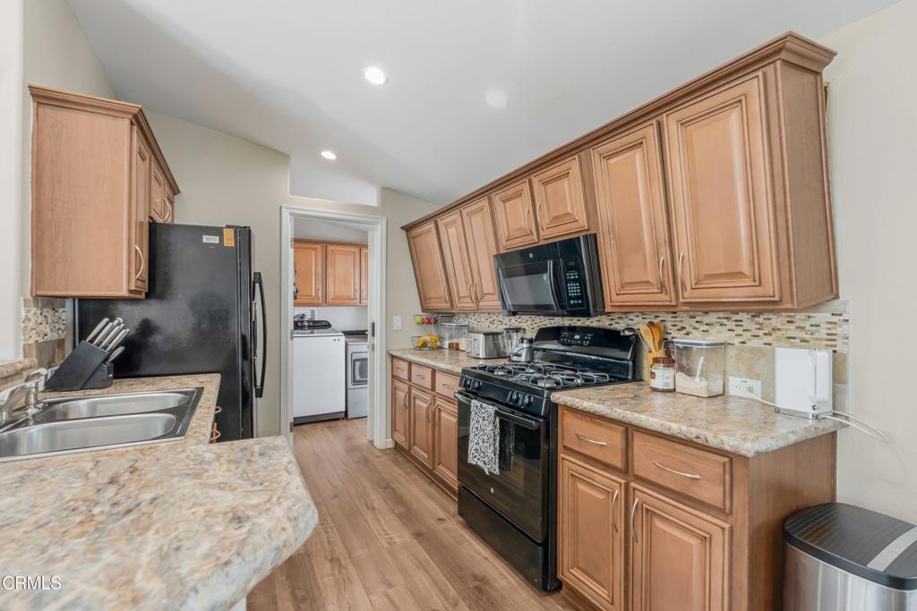 250 East Telegraph Road, Unit 155 Fillmore, CA 93015 - Photo 9 of 39 a kitchen with stainless steel appliances granite countertop a refrigerator stove microwave and sink