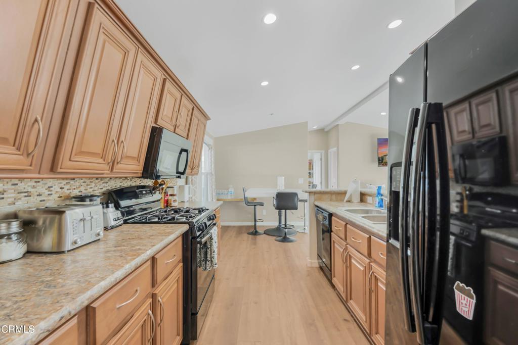 250 East Telegraph Road, Unit 155 Fillmore, CA 93015 - Photo 10 of 39 a kitchen with stainless steel appliances granite countertop a refrigerator a stove and a sink