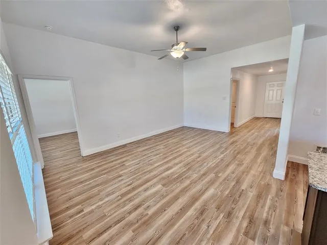 wooden floor in an empty room with a mirror