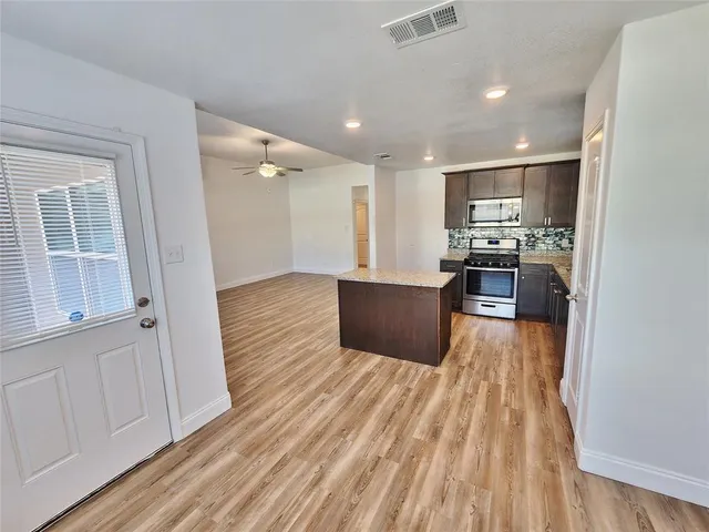 a large house with a yard and wooden fence