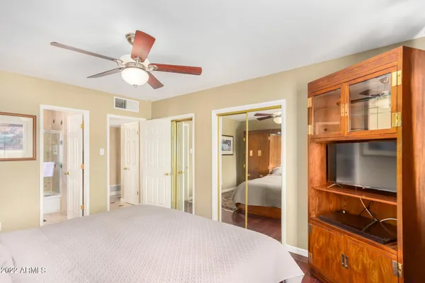 a bedroom with a bed and a chandelier