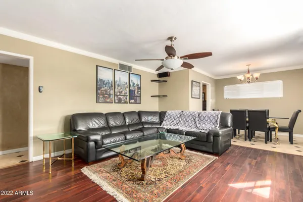 a living room with furniture and wooden floor