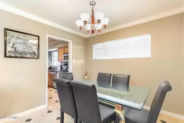 a dining room with furniture and chandelier