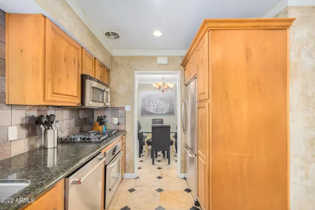 a kitchen with stainless steel appliances granite countertop a granite counter tops and a window