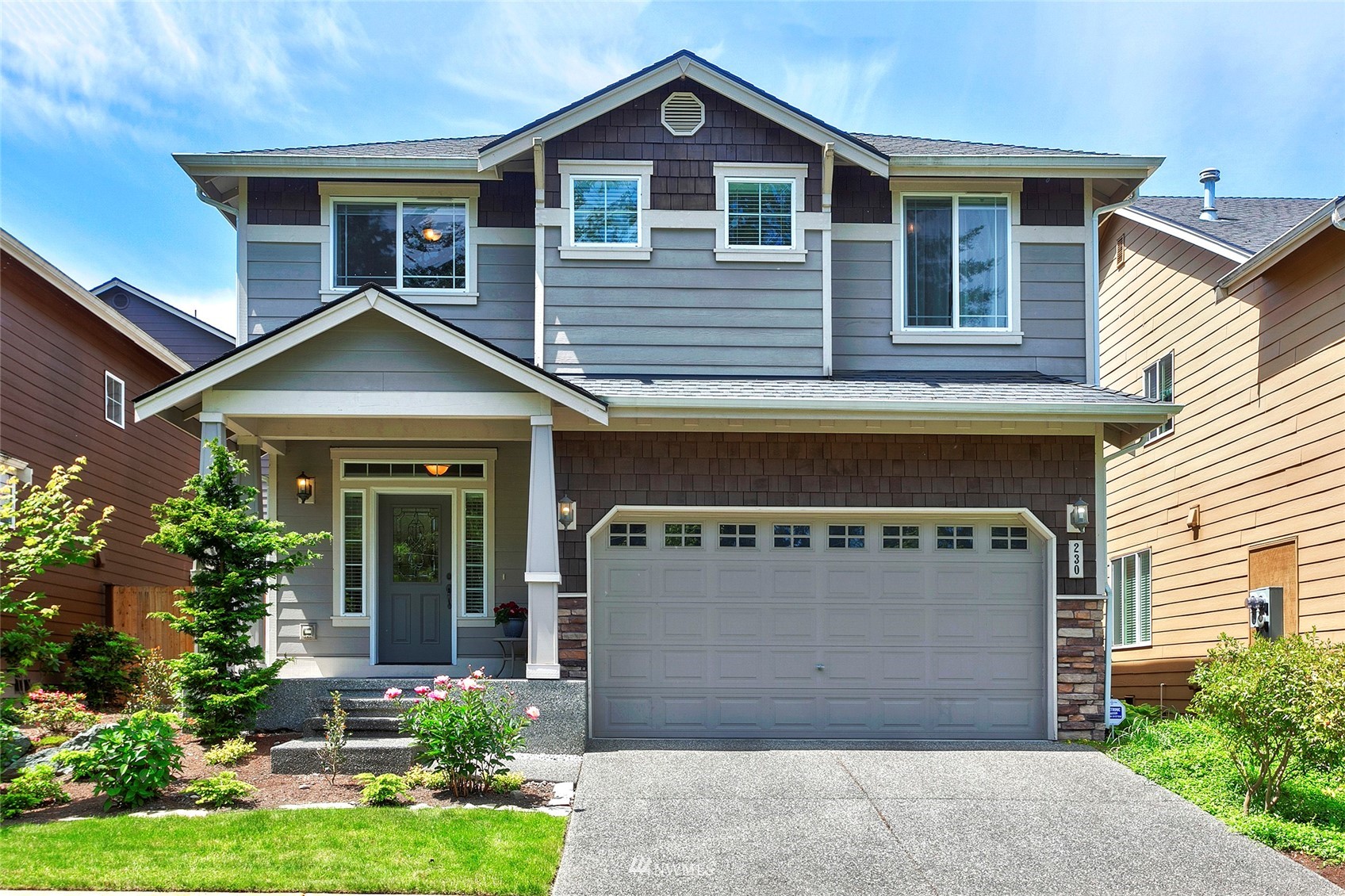 230 161st Place Southeast Bothell, WA 98012 - Photo 1 of 22 a front view of a house with a yard and garage