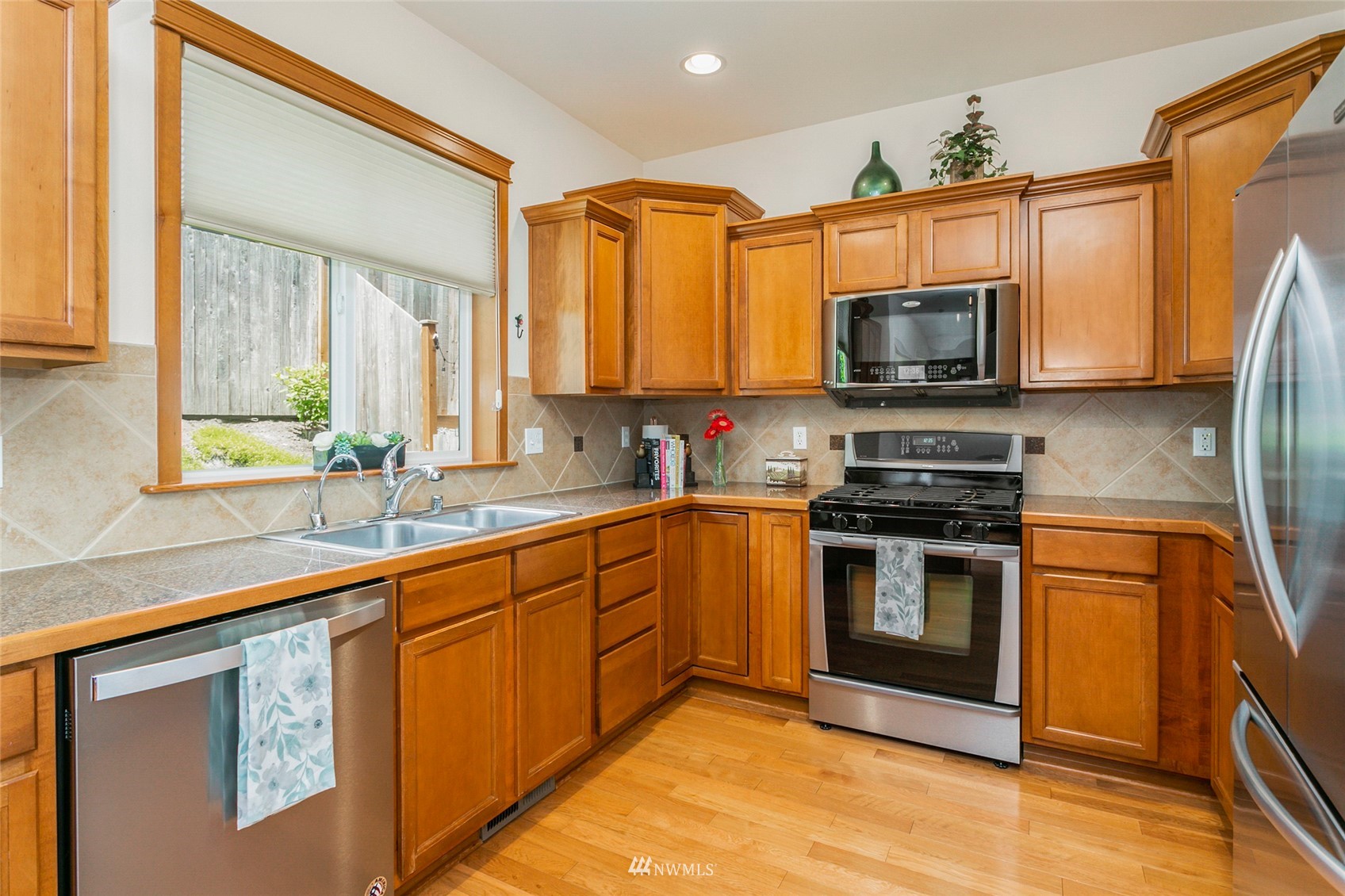 230 161st Place Southeast Bothell, WA 98012 - Photo 7 of 22 a kitchen with stainless steel appliances granite countertop a stove microwave sink and refrigerator