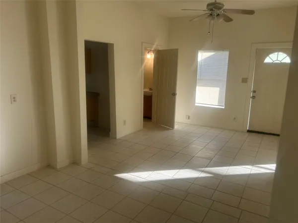 a kitchen with a stove a refrigerator and a window