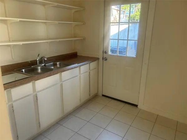 a white toilet and tub sitting next to a bathroom sink