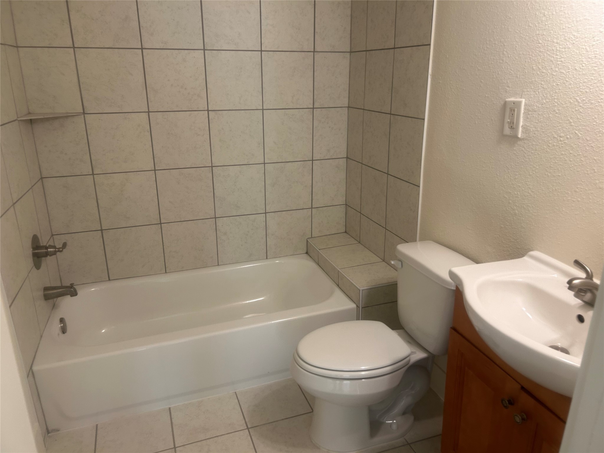 602 Cordell Street Houston, TX 77009 - Photo 7 of 13 a white toilet and tub sitting next to a bathroom sink