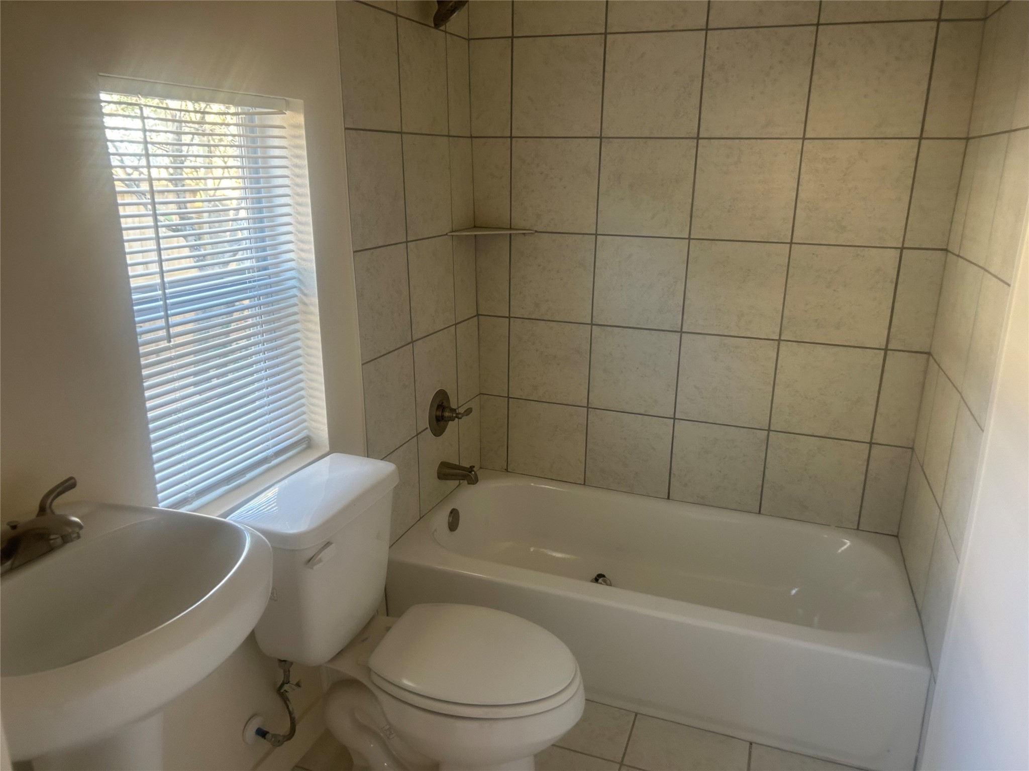602 Cordell Street Houston, TX 77009 - Photo 9 of 13 a white toilet and tub sitting next to a bathroom sink