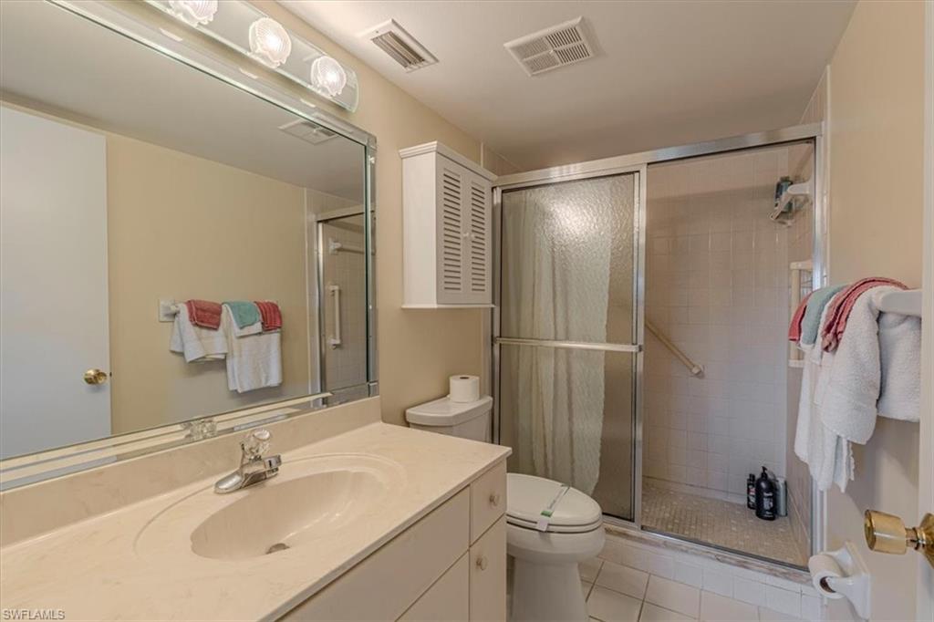 5483 Rattlesnake Hammock Road, Unit B201 Naples, FL 34113 - Photo 13 of 22 a bathroom with a sink toilet and shower