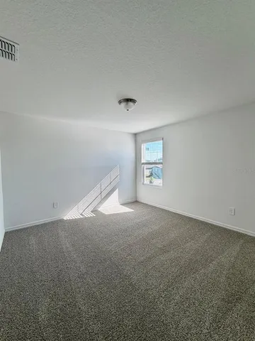 a view of an empty room and a window