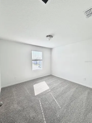 a view of an empty room and a window