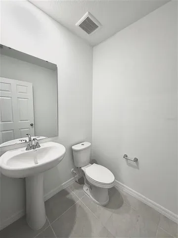 a bathroom with a double vanity sink toilet mirror and bathtub